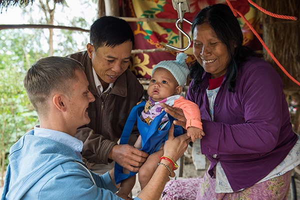 Peace Corps volunteer working with a family