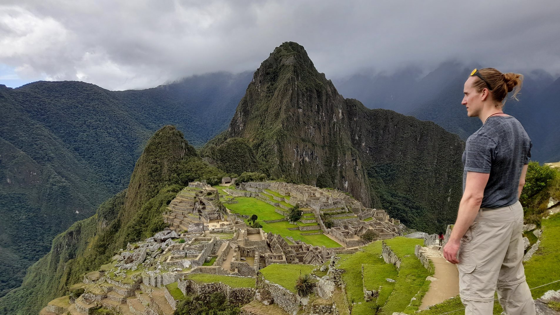 Man looking down on a view of Machu Picchuu in Peru