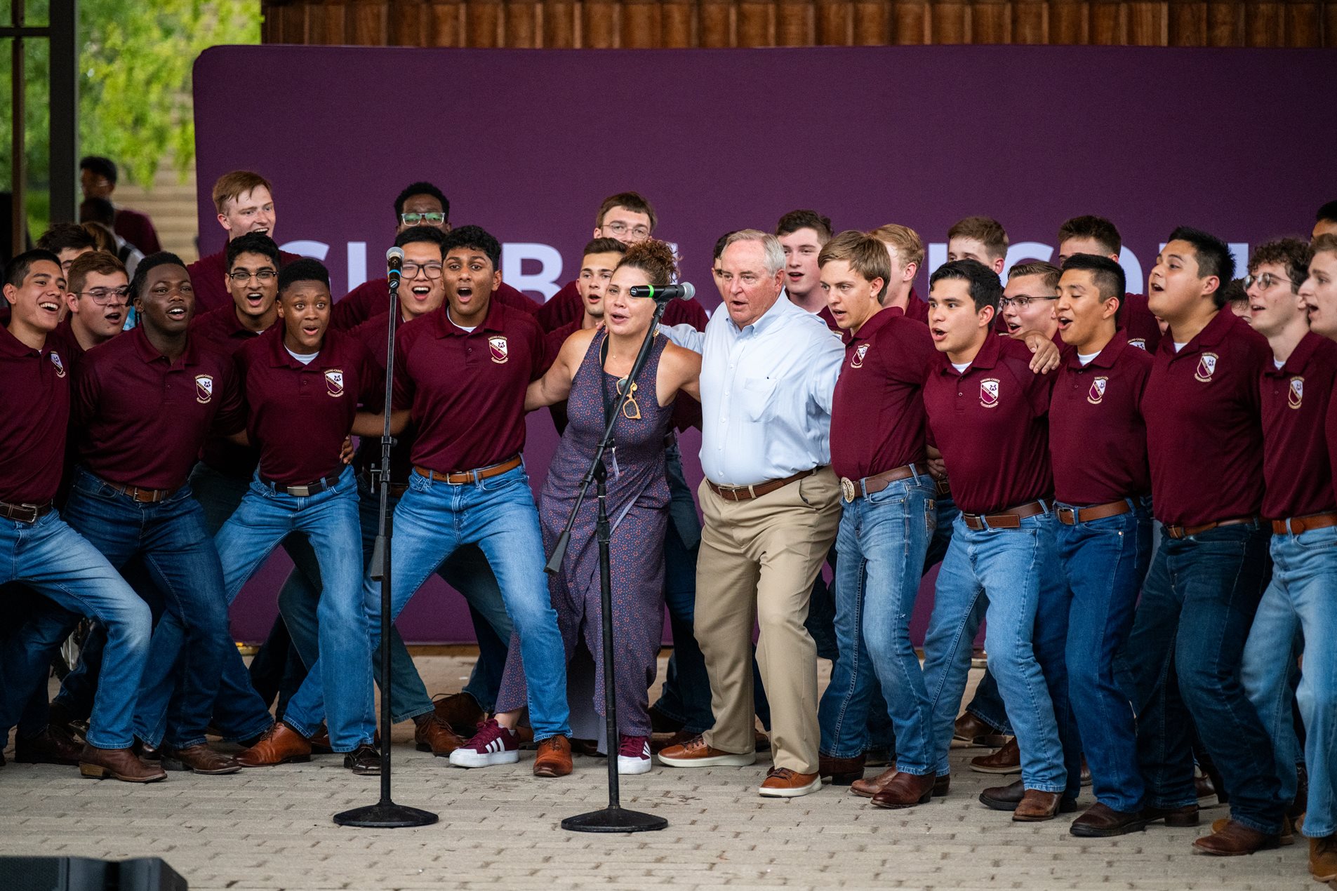 President Mark A. Welsh III, Dr. Holly Hudson, and the Singing Cadets participate in the Texas A&M War Hymn.